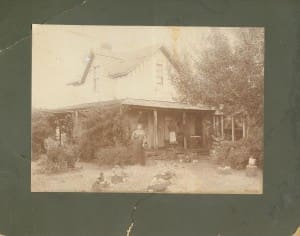 susan hart in front of wood house